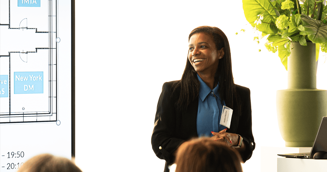 Photo of Jessica smiling gracefully while giving a presentation