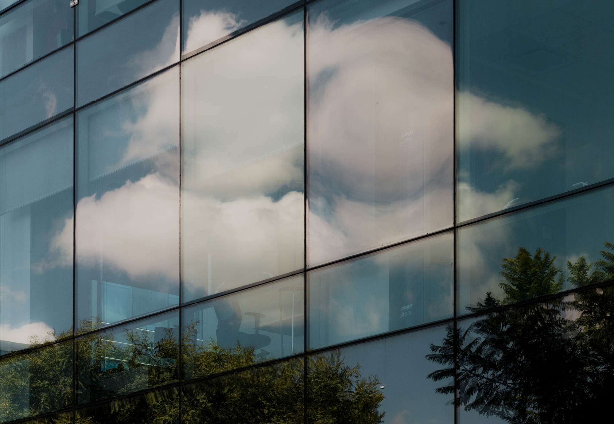 Office building with reflection of clouds in the facade